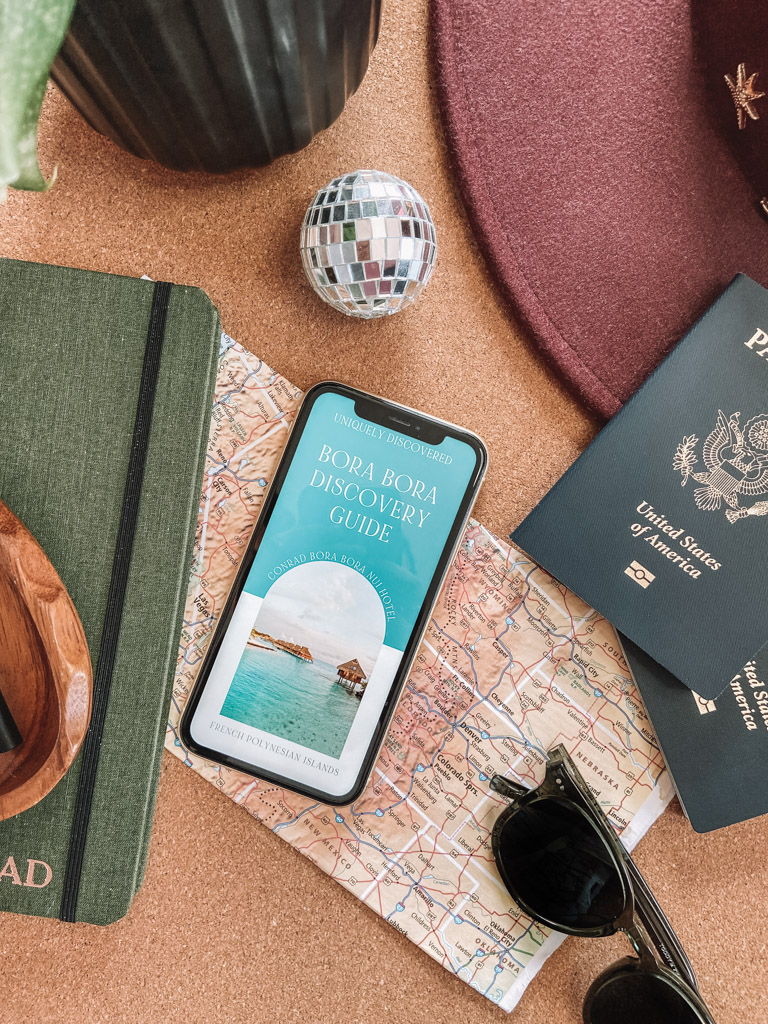 Flat lay of a regional map and hospitality branding materials, representing the "District Authority" and digital discovery phase of a property alignment review.